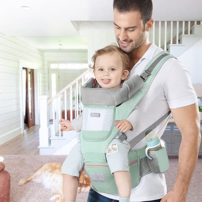 Porte-bebe vert menthe avec assise et poches latérales.