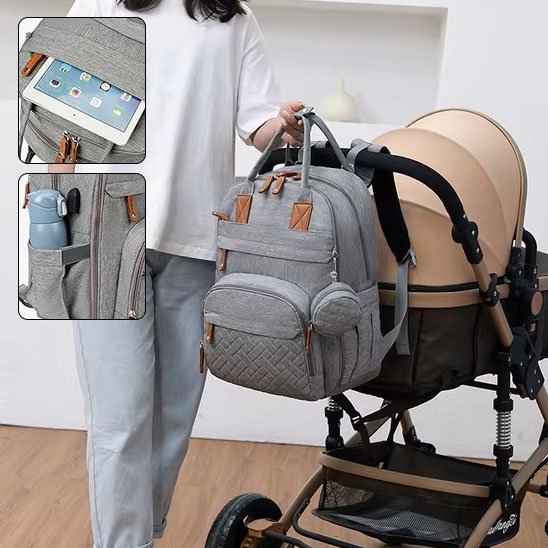 Sac à langer gris pour parents, avec rangements pour biberons.